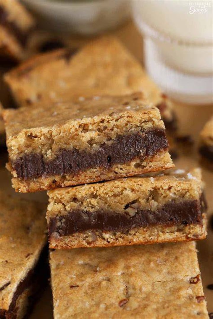 Closeup of a fudge stuffed blondie torn into two pieces.
