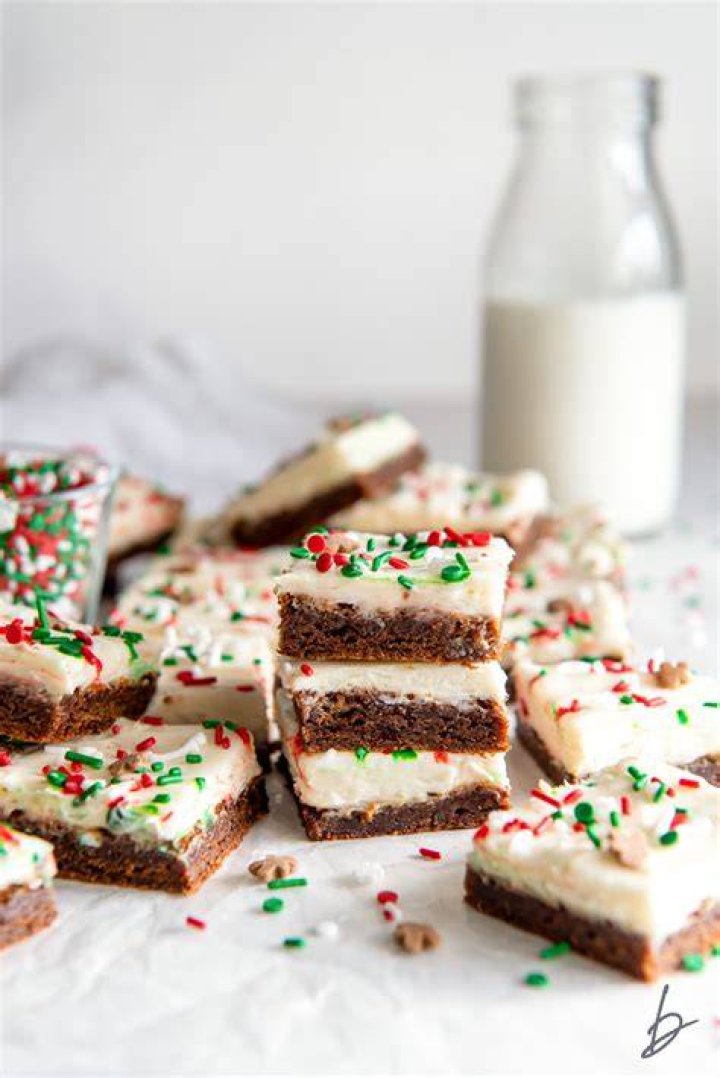 Stack of gingerbread cookie bars filled with white chocolate chips.