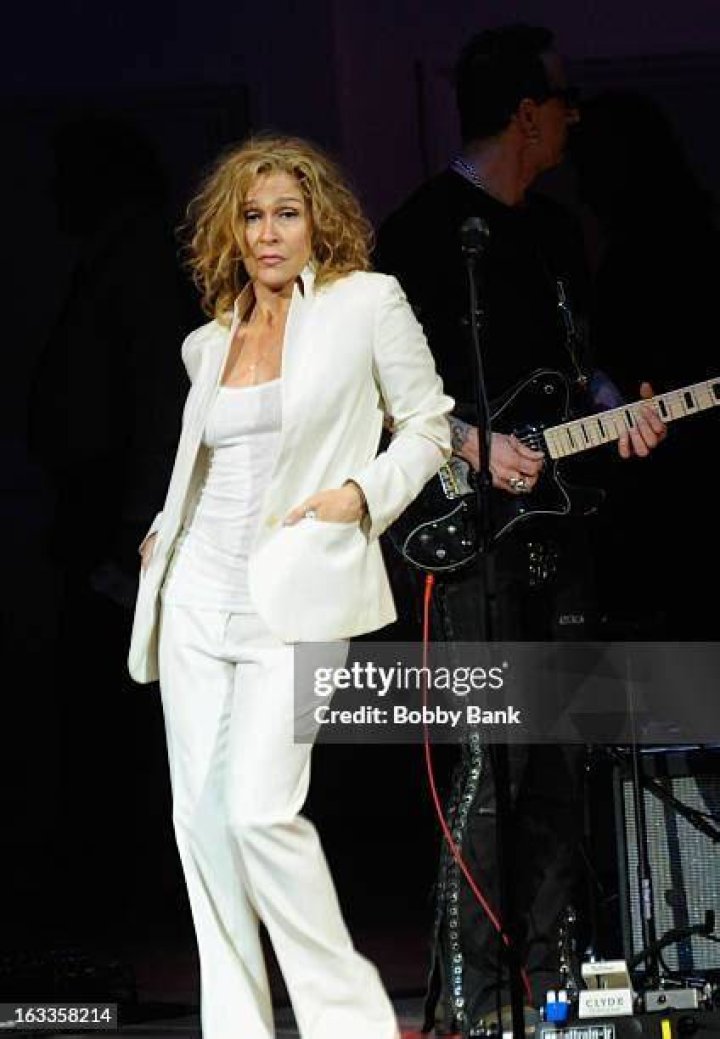 Susannah Melvoin in a white coat poses for a photoshoot.